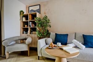 a living room with a couch and a table at Apartamenty In Hygge Jastrzębia Góra in Jastrzębia Góra