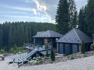 a log cabin with a staircase leading to a house at Шишка in Bukovel