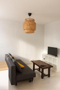 a living room with a couch and a coffee table at Appartement avec parking La Flocellière in La Flocellière