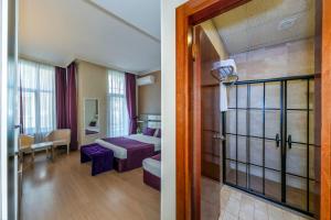 a hotel room with a bed and a room with a door at Nil Hotel İstanbul City Center in Istanbul