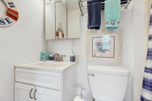 a white bathroom with a sink and a toilet at The Canal House --- 30131 New Castle Rd in Dagsboro +18 photos