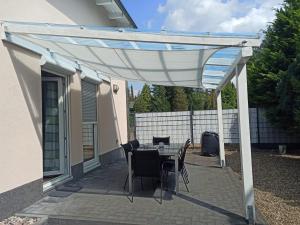 a pergola on a patio with a table and chairs at Dream Days , House in Stüde