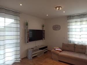 a living room with a couch and a flat screen tv at Dream Days , House in Stüde