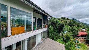 a balcony of a house with mountains in the background at Royal Lion Hotel - Kandy Road, Galagadara in Galagedara