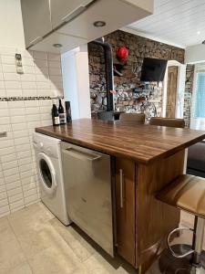 a kitchen with a counter with a washer and dryer at Location Patrimonio in Patrimonio