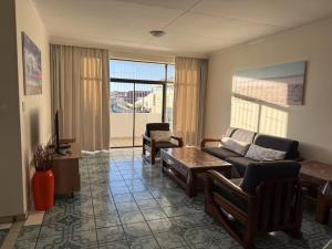 a living room with a couch and a table at Home Inn Self-Catering in Windhoek