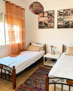 a bedroom with two beds and a window at Alcudia Smir Complex piedras del Mar in Fnidek +10 photos