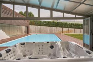 a bath tub in a house with a swimming pool at El Merendero de Burgos 