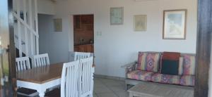 a living room with a table and a couch at Beach On High in Ramsgate