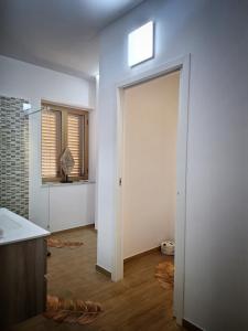 a hallway with a door to a room with a window at La Maison de Maria en Calabre in Campora San Giovanni +15 photos