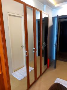 a room with a door and a mirror at Great Location, Swimming pool, Shops, Staycation in Iloilo City