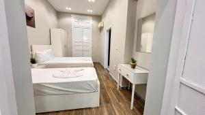 a small room with two beds and a desk at charming studio in Cairo