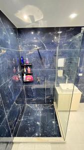 a bathroom with a sink and a blue tiled wall at charming studio in Cairo +38 photos