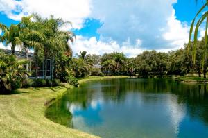 a pool of water with palm trees in a park at Beach Bliss in Bradenton