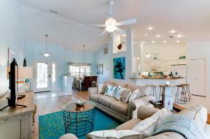 a living room with a couch and a table and a kitchen at Beach Bliss in Bradenton