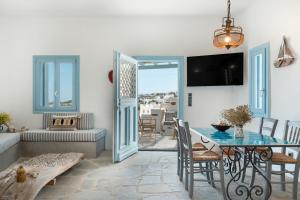 a living room with a table and a couch at Sylvia's Home in Sifnos
