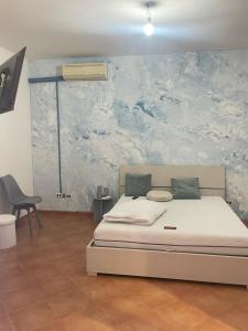 una camera da letto con un letto e un quadro sul muro di Casa vacanza Foceverde lido a Lido di Latina