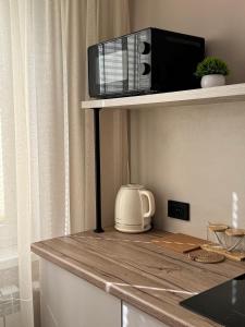 a microwave sitting on top of a counter at Квартира 2-комнатная in Balqash