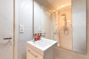 a white bathroom with a sink and a shower at La maison d'Acoya in Valdeblore +7 photos
