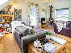 a living room with a couch and a table at 3 Bed in Southerndown 57715 in Southerndown