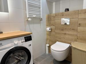 a bathroom with a washing machine and a toilet at B50 Trzy Lipki - Apartament Bielsko - WGH Rent in Bielsko-Biala +37 photos