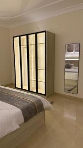a bedroom with a bed and a large window at HomeStay in Jeddah