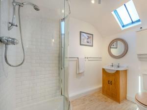a bathroom with a shower and a sink at 5 Bed in Bassenthwaite 89496 in Torpenhow +34 photos