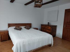 a bedroom with a white bed with two pillows on it at Renovated traditional house - Rustic Escape in Şapartoc