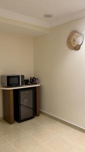 a microwave sitting on a counter in a room at HomeStay in Jeddah +5 photos