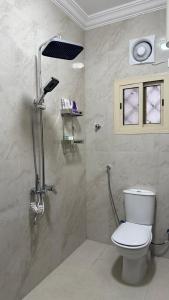 a bathroom with a toilet and a shower at HomeStay in Jeddah +5 photos