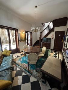a living room with a table and chairs at Residencia Boutique in Mar del Plata