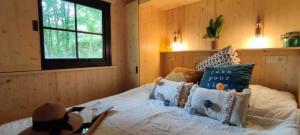 a bedroom with a bed with a sign on it at Cabane 3 étoiles - eeiici in Meyssac +18 photos