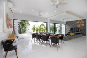 a kitchen and dining room with a table and chairs at Villa Brianna Luxuria 2 - Rawai in Phuket Town
