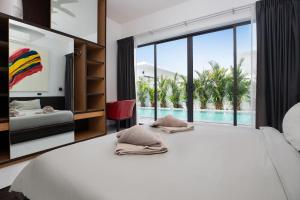a bedroom with a large white bed and a large window at Villa Brianna Luxuria 2 - Rawai in Phuket Town +34 photos