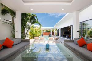 a living room with a couch and a table at Villa Brianna Luxuria 2 - Rawai in Phuket Town