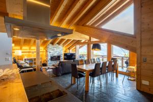 a kitchen and dining room with a table and chairs at Montagnard 12 - spa access - car and careless holidays! in Nendaz