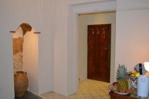 a room with a door and a table with a pineapple at Domus Lina in Ravello