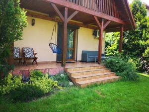 a porch of a house with a blue bench and stairs at Ustroń Dom Aneta in Ustroń