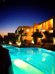 una gran piscina azul frente a un edificio en Rodon Hotel, en La Canea