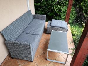 two wicker chairs and a table on a patio at Ustroń Dom Aneta in Ustroń
