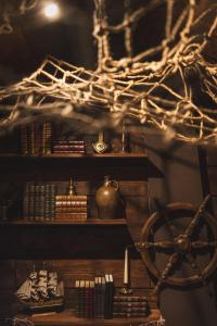 a room with a shelf with books and a wheel at 1 maison 5 décors de films cultes Minerva Studio  +32 photos