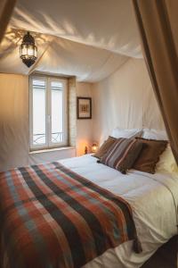 a bedroom with a large bed in a tent at 1 maison 5 décors de films cultes Minerva Studio 