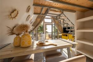 a dining room with a wooden table and chairs at Olive Frame in Zakynthos