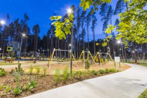 a playground at a park at night with lights at Key to Jurmala in Jūrmala