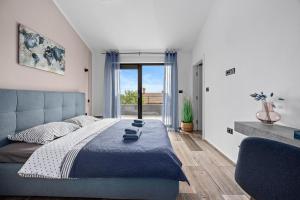 a bedroom with a large bed and a large window at Villa Kali by IstriaLux in Krnica +38 photos