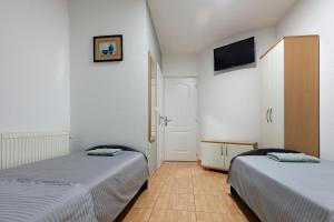 a room with two beds and a tv on the wall at Villa Miranda NG in Ohrid +31 photos