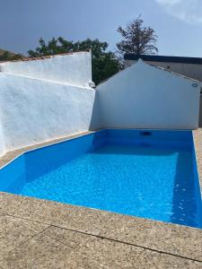 a swimming pool with a ramp and blue water at Casa Rural El Gallo in Casas de Haro