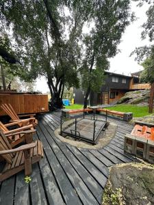 a wooden deck with benches and tables on it at Bosque in Antuco +7 photos