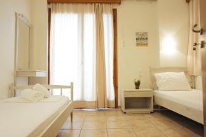 Postel nebo postele na pokoji v ubytování Faros Hotel