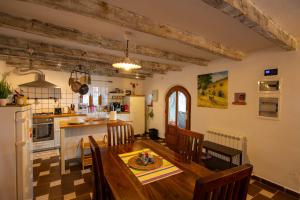 a kitchen and dining room with a table and chairs at The Shire in Poljane